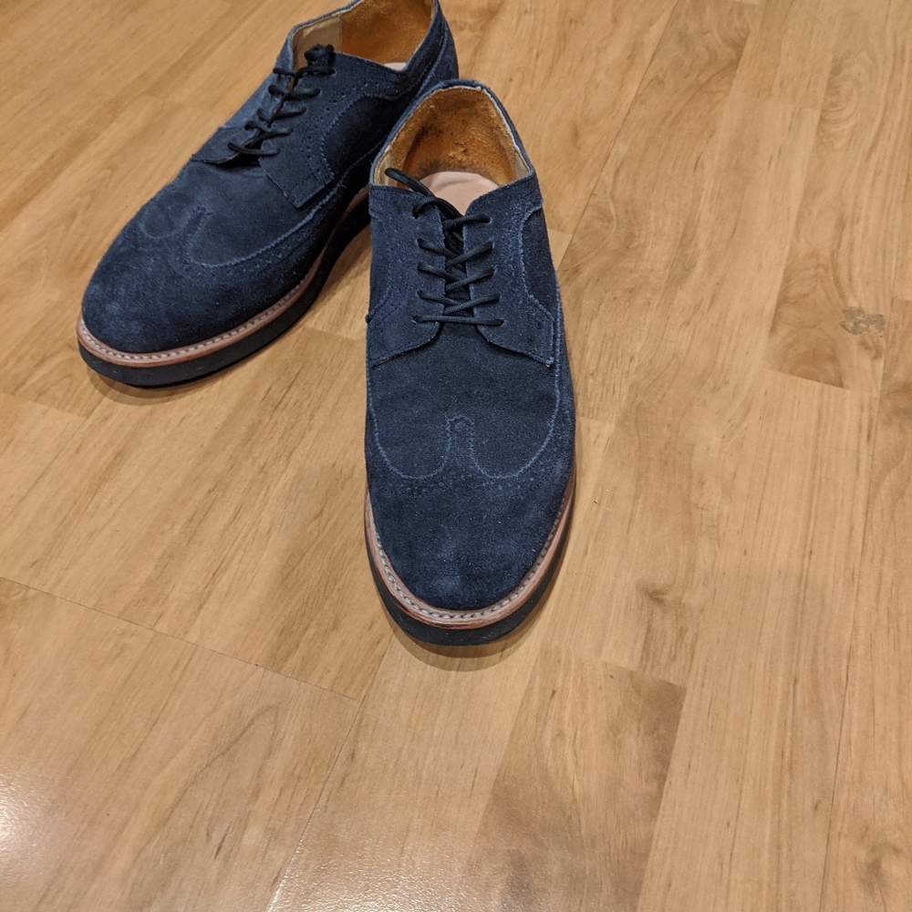Unmarked blue suede wingtip derby with black cork
